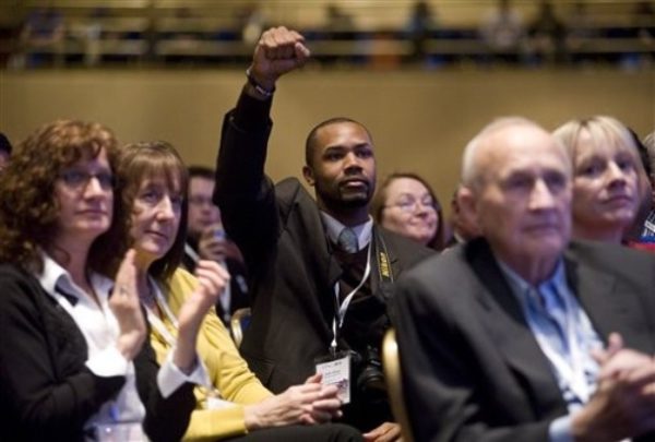 Andre Harper pumps his fist in the air salute as former Massachusetts Gov. Mitt Romney addressed the Conservative Political Action Conference (CPAC), in Washington, Thursday, Feb. 18, 2010. (AP Photo/Cliff Owen)