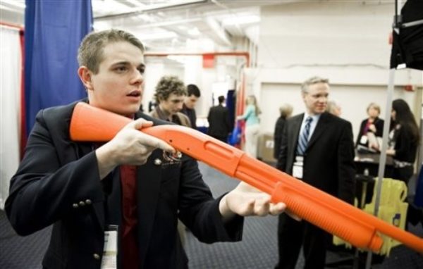 Alex Gerrard of Bolling Green, Ky., tries his shotgun shooting skills at an NRA shooting simulator during the Conservative Political Action Conference (CPAC) in Washington, Thursday, Feb. 18, 2010. (AP Photo/Cliff Owen)