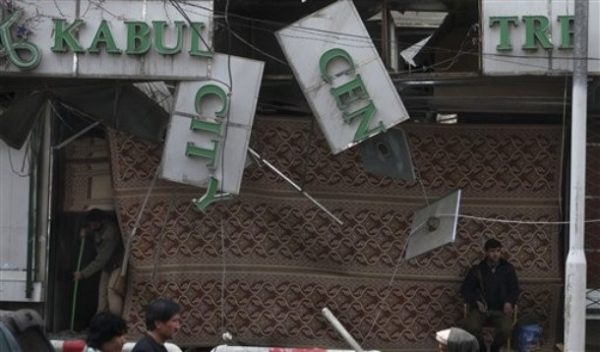 A worker cleans the floor of a building building a day after the suicide attacks in Kabul, Afghanistan, Saturday, Feb. 27, 2010. The clean-up in central Kabul began on Saturday after suicide attackers and a car bomb a day earlier killed at least 16 people and wounded dozens. (AP Photo/Altaf Qadri)