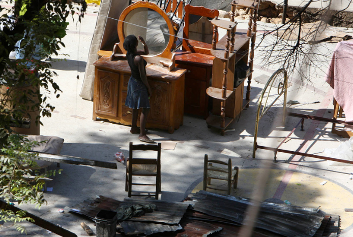 Woman looking in mirror in Haiti