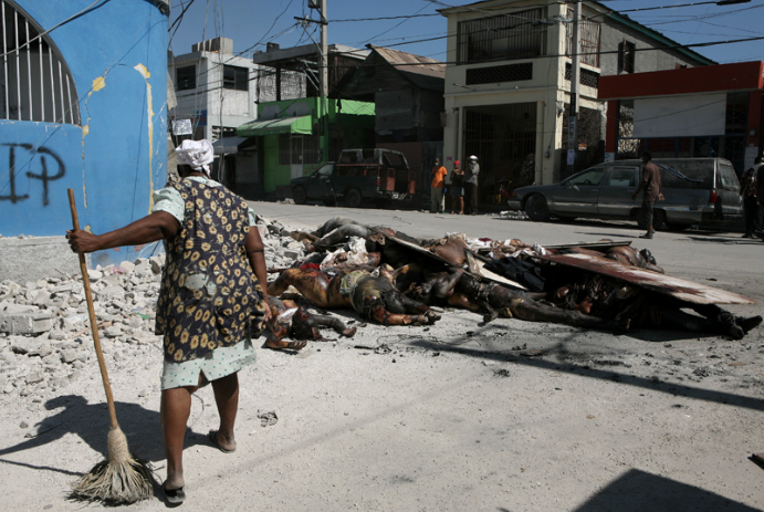 Woman sweeping in Haiti