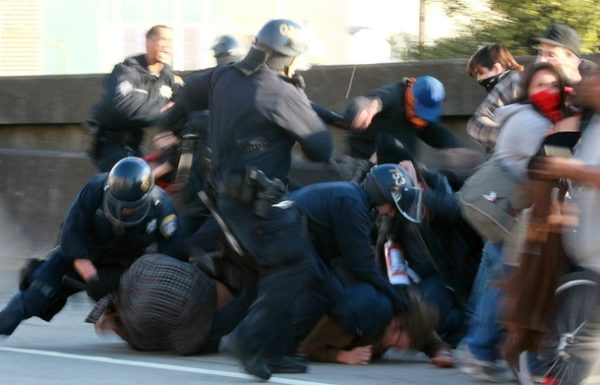 OAKLAND, CA - MARCH 04: Oakland police officers take down a splinter group of protestors that attempted to block Interstate 880 following a rally for the national day of action against school funding cuts and tuition increases March 4, 2010 in Oakland, California. Dozens of protestors were arrested after they stormed the 880 freeway as students across the country are walking out of classes and holding demonstrations against massive tuition increases and funding cuts to college universities. (Photo by Justin Sullivan/Getty Images)