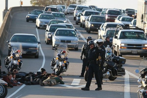 OAKLAND, CA - MARCH 04: Protestors lay face down on Interstate 880 after they were arrested by Oakland police officers for attempting to block the freeway following a rally for the national day of action against school funding cuts and tuition increases March 4, 2010 in Oakland, California. Dozens of protestors were arrested after they stormed the 880 freeway as students across the country are walking out of classes and holding demonstrations against massive tuition increases and funding cuts to college universities. (Photo by Justin Sullivan/Getty Images)