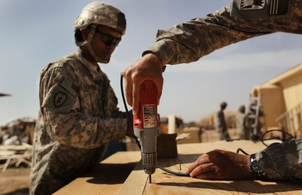 FORWARD OPERATING BASE RAMROD, AFGHANISTAN - MARCH 11: U.S. Army carpenters from the 60th Engineer Company construct a new command center while expanding an American military base for incoming troops on March 11, 2010 at Forward Operating Base Ramrod in Kandahar province, Afghanistan. U.S. bases across southern Afghanistan are being enlarged to accommodate the surge of fresh troops ordered by President Obama as part of the new war strategy. (Photo by John Moore/Getty Images)