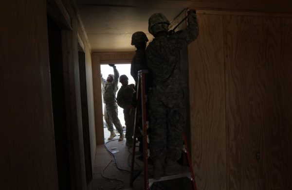 FORWARD OPERATING BASE RAMROD, AFGHANISTAN - MARCH 11: U.S. Army carpenters from the 60th Engineer Company construct a new command center while expanding an American military base for incoming troops on March 11, 2010 at Forward Operating Base Ramrod in Kandahar province, Afghanistan. Bases across southern Afghanistan are being enlarged to accommodate the surge of fresh troops ordered by President Obama as part of the new war strategy. (Photo by John Moore/Getty Images)