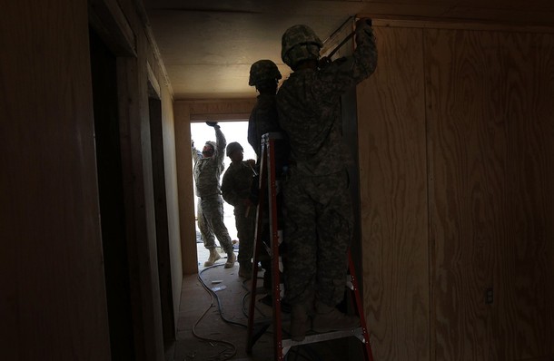 FORWARD OPERATING BASE RAMROD, AFGHANISTAN - MARCH 11:  U.S. Army carpenters from the 60th Engineer Company construct a new command center while expanding an American military base for incoming troops on March 11, 2010 at Forward Operating Base Ramrod in Kandahar province, Afghanistan. Bases across southern Afghanistan are being enlarged to accommodate the surge of fresh troops ordered by President Obama as part of the new war strategy.  (Photo by John Moore/Getty Images)