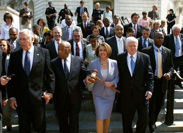 WASHINGTON - MARCH 21: Speaker of the House Rep. Nancy Pelosi (D-CA) (C) carries the gavel that was used when Medicare was passed while marching with Rep. John Lewis (D-GA) (2L), Majority Leader Rep. Steny Hoyer (D-MD) (L), Rep. John Larson (2R) (D-CT), Rep. Chris Van Hollen (D-MD) and other members of the Democratic Caucus from the Cannon House Office Building to the U.S. Captiol for the health care reform vote March 21, 2010 in Washington, DC. House Majority Leader Steny Hoyer (D-MD) said he was confident that the Democrats have the necessary 216 votes to pass landmark health care reform legislation today. (Photo by Chip Somodevilla/Getty Images)