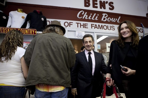 French President Nicolas Sarkozy and wife Carla Bruni-Sarkozy walk together at Ben's Chili Bowl in Washington
