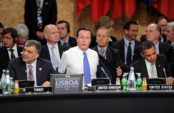 United Kingdom's Prime Minister David Cameron (C) gestures between US President Barack Obama (R) and Turkey's President Abdullah Gul as the NRC (NATO-Russia Council) starts on November 20, 2010 in Lisbon, as part of a NATO (North Atlantic Treaty Organization) Summit of Heads of States and Government held on 19-20 November 2010.   AFP PHOTO/ TIM SLOAN (Photo credit should read TIM SLOAN/AFP/Getty Images)