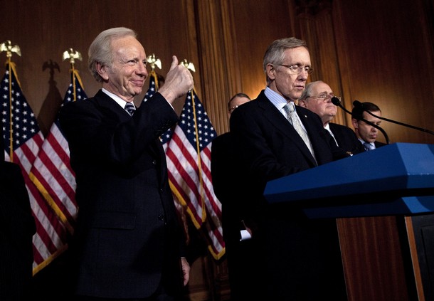 WASHINGTON - DECEMBER 18:  Senator Joseph Lieberman (I-CT) (L) gives a thumbs up while arriving with Senate Majority Leader Harry Reid (D-NV) and others for a press conference on a procedural vote on a "Don't Ask, Don't Tell" repeal on Capitol Hill December 18, 2010 in Washington, DC.  The Senate passed cloture on the National Defense Authorization Act for Fiscal Year 2011 and is expected to vote for final passage on the bill later today.(Photo by Brendan Smialowski/Getty Images)