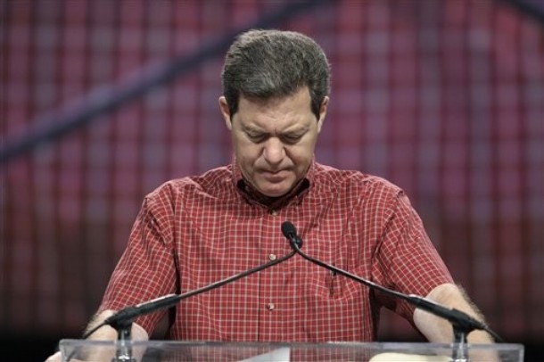 Kansas Gov. Sam Brownback prays at The Response, a call to prayer for a nation in crisis, Saturday, Aug. 6, 2011, in Houston. Texas Gov. Rick Perry also participated in the event. (AP Photo/David J. Phillip)