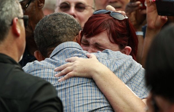 Stephanie Miller of Sandusky Ohio cries on the shoulder of U.S. President Barack Obama at a campaign event at Washington Park in Sandusky, Ohio July 5, 2012. Miller's sister died of cancer and said that Obama's healthcare plan would have given her better treatment options.  REUTERS/Kevin Lamarque  (UNITED STATES - Tags: POLITICS)