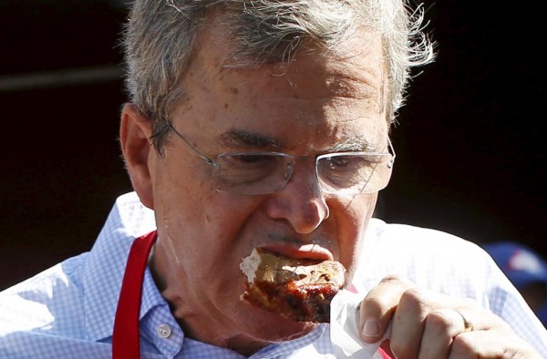 U.S. Republican presidential candidate Bush eats a pork chop as he campaigns at the Iowa State Fair in Des Moines