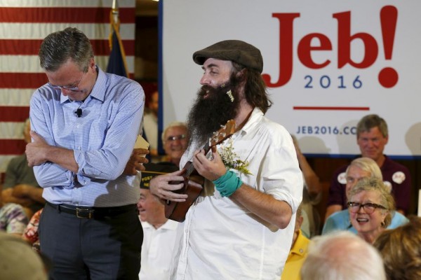 Republican presidential candidate Jeb Bush reacts as Rob Webber sings a political song for him at a campaign town hall meeting in Laconia, New Hampshire September 3, 2015. REUTERS/Brian Snyder