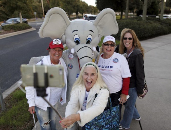 Charmaine Adamo takes a selfie with friends and a Trump mascot "Trumpie" before a rally by U.S. Republican presidential candidate Donald Trump at the Myrtle Beach Convention Center in Myrtle Beach, South Carolina, November 24, 2015. REUTERS/Randall Hill