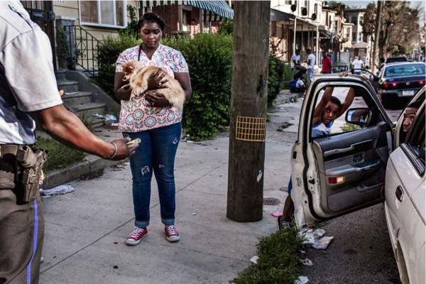 Officers Damon Linder and Edwin Vaughn speak to neighbors, threatening to impound a car which was being driven by a man without a license in West Philadelphia. Ultimately the man was ticketed and the car was released to a licensed driver. July 31, 2015. Philadelphia, Pa. Natalie Keyssar for TIME. July 31st, 2015. Philadelphia.