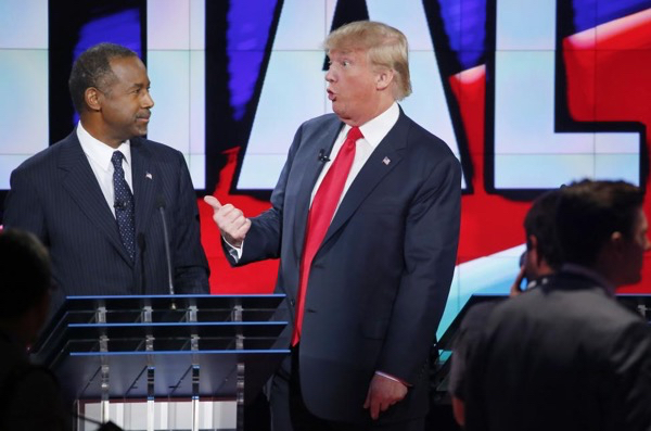 Donald Trump talks with Ben Carson during a commercial break at the GOP debate.