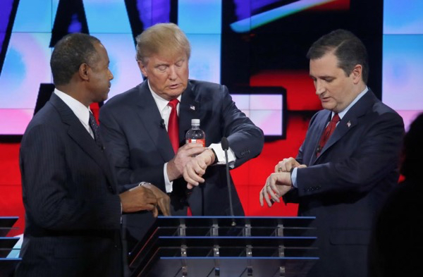 Donald Trump and Ted Cruz check their watches during a commercial break as Ben Carson looks on during the GOP debate.
