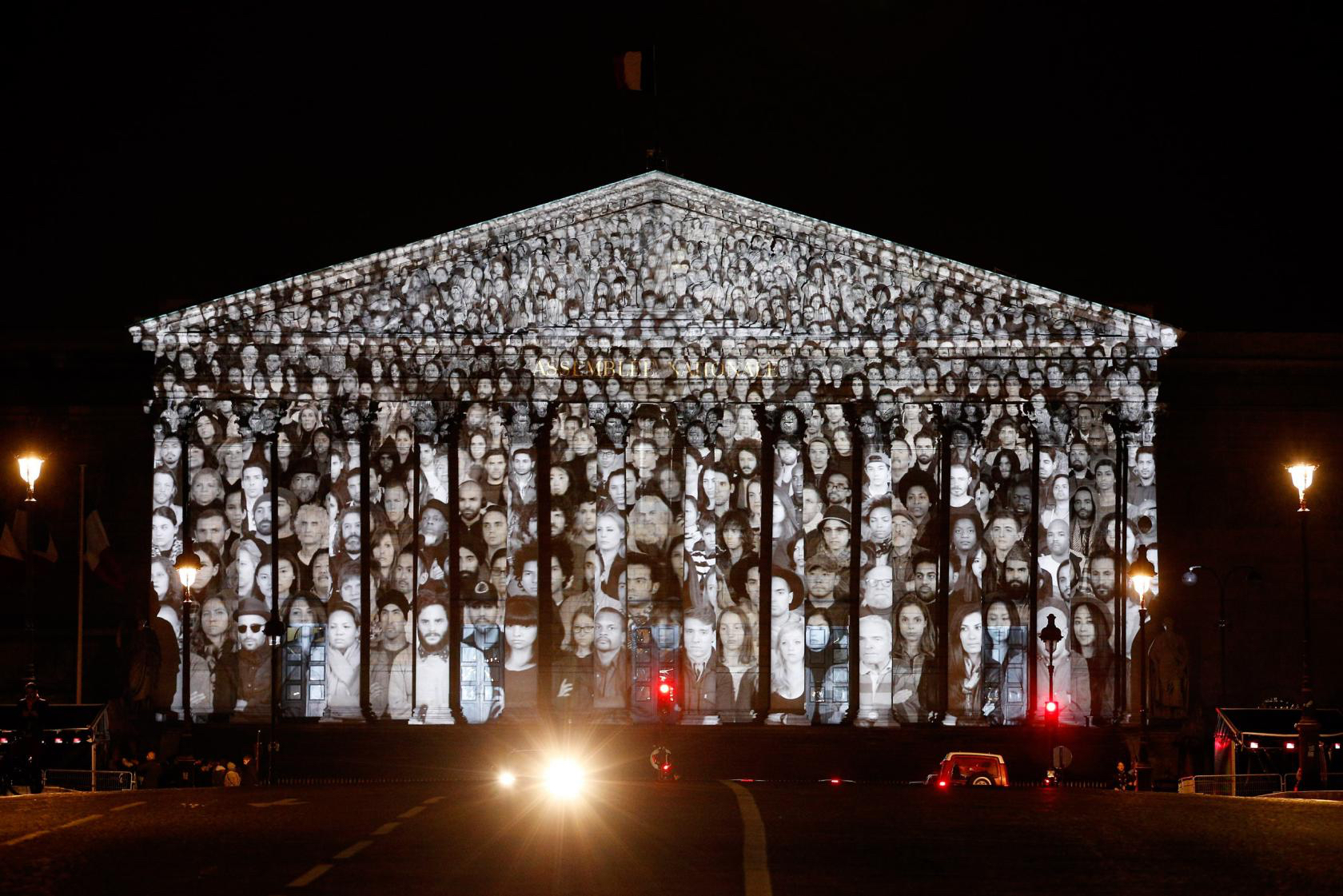 epa05048047 An artwork by French artist JR and US filmmaker Darren Aronofsky is projected onto the French National assembly (Parliament) on the eve of the COP21 climate conference in Paris, France, 29 November 2015. The 21st Conference of the Parties (COP21) due to be held in Paris from 30 November to 11 December will proceed as planned, despite the terrorist attacks of 13 November. EPA/YOAN VALAT