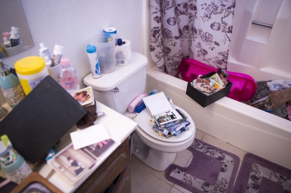 Photos lie inside the bathroom of the home of the San Bernardino attackers in Redlands, Calif.