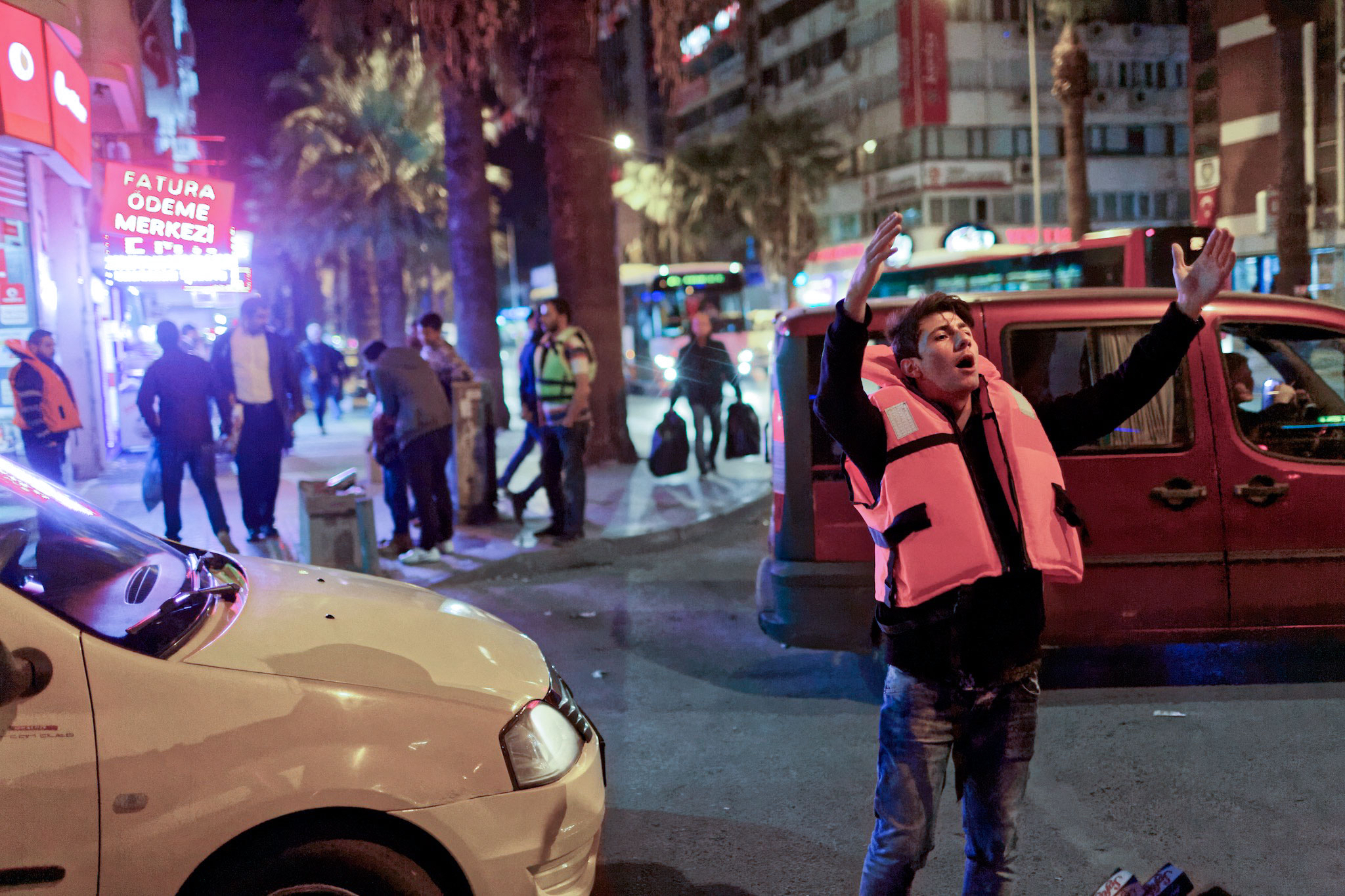 Picture of a young man selling life jackets on the streets of Izmir, Turkey