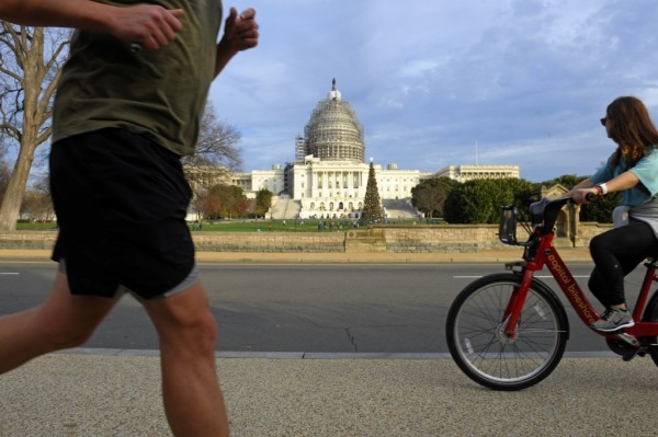 Warmest winter DC. A biker and jogger dart past the Capitol Christmas tree on Dec. 13. Temperatures are slated to peak on Christmas Eve in Washington in the 70s, approximately 35 degrees above average. 