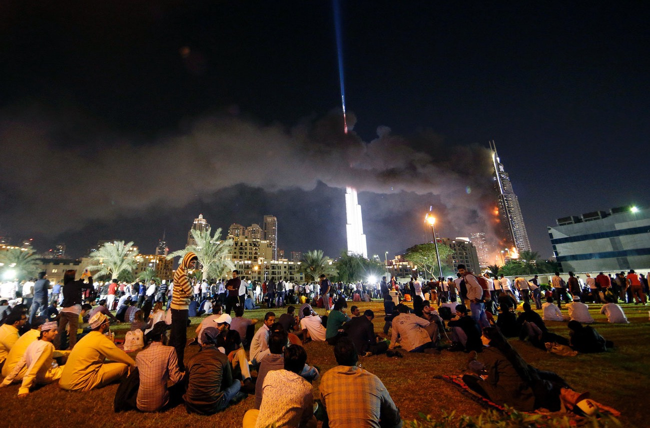 A fire burns at the Address hotel in downtown Dubai as people await New Year's fireworks over the Burj Khalifa.