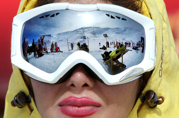 In this Friday, Jan. 15, 2016 photo, an Iranian skiers are reflected in the goggles of a skier at Dizin Ski Resort some 72 kilometers (45 miles) north of the capital Tehran, Iran. Every weekend, the resort in the Alborz mountain range, north of Tehran, draws hundreds of skiers from the capital and other towns. (AP Photo/Ebrahim Noroozi)