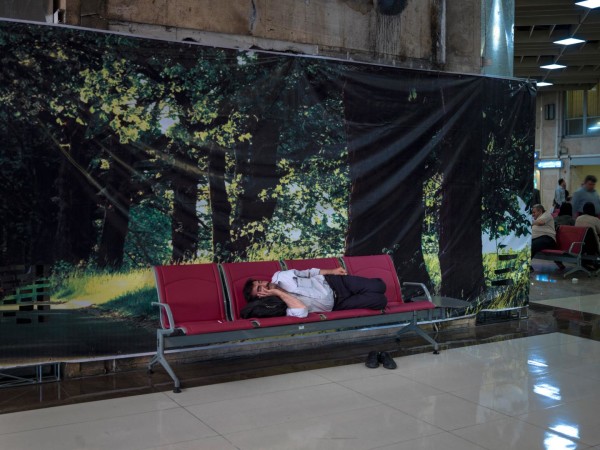 A man sleeping on a bench in Tehran's domestic Mehrabad airport. Iran is in dire need of new planes following years of limitations on buying planes.
