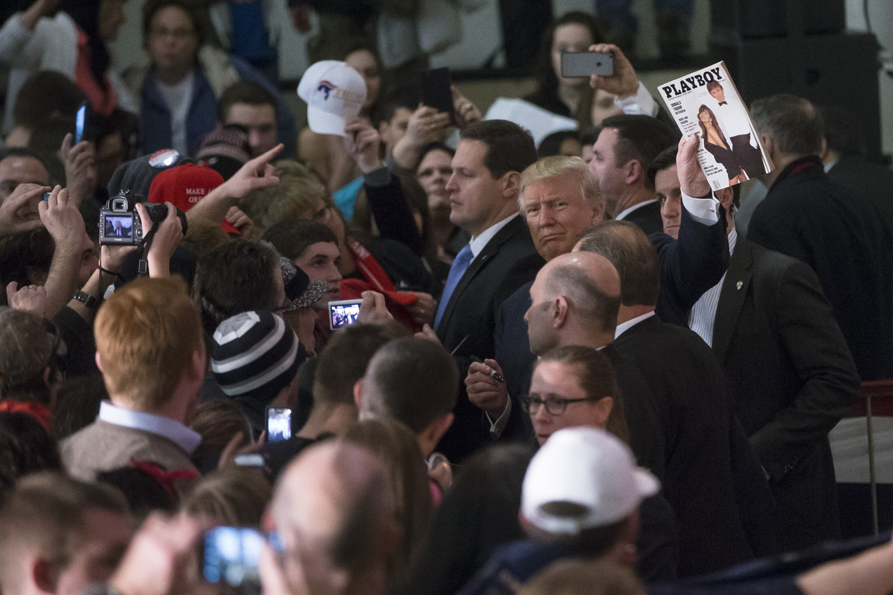photo: John Minchillo/AP. caption: Donald Trump, shown Monday in Farmington, N.H., held a copy of a 1990 Playboy magazine where he is depicted on the cover. 