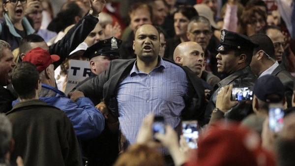 Law enforcement officers escort a man from a campaign event for Republican presidential candidate Donald Trump in Worcester, Mass. November 2015. Steven Senne/AP