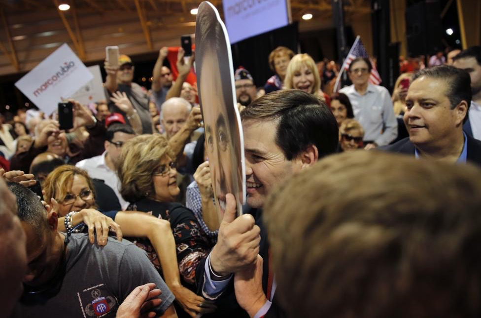 Carlos Barria/Reuters: Republican presidential candidate Senator Marco Rubio holds a cutout of his head in front of his face as he greets supporters after speaking about the Super Tuesday primary and caucus voting results at a campaign rally in Miami, Florida March 1, 2016.