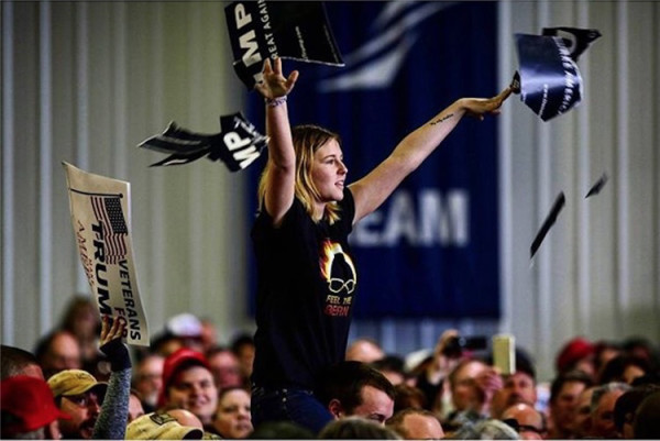 photo: JoshuaLott/Instagram. caption: A Protester Tears Apart A Donald Trump Campaign Sign As Trump Spoke During A Campaign Event At The Central Illinois Regional Airport.