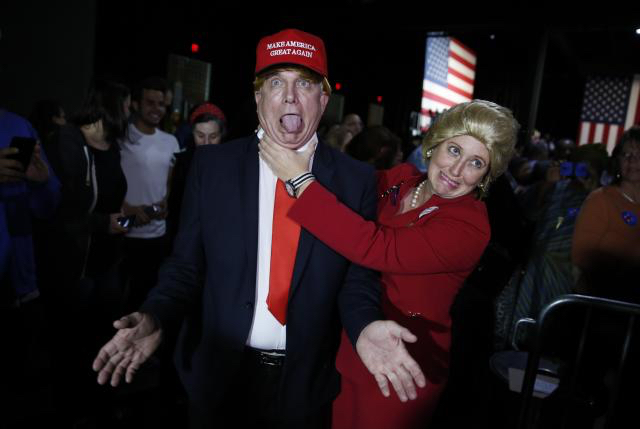 Jonathan Ernst/Reuters: Supporters of Democratic presidential candidate Hillary Clinton, who came to her rally in costume as Republican presidential candidate Donald Trump (L) and as Mrs. Clinton (R), clown around as they attend her Super Tuesday night party in Miami, Florida, March 1, 2016.