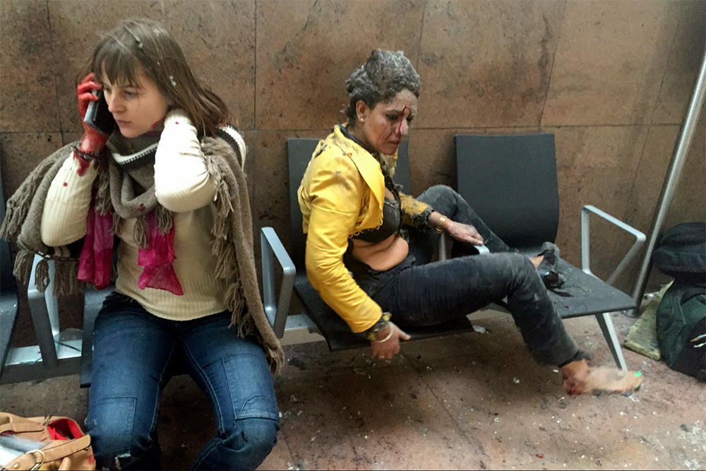 photo: Ketevan Kardava—Georgian Public Broadcaster/AP; Caption: In this photo provided by Georgian Public Broadcaster and photographed by Ketevan Kardava, two women are wounded in Brussels Airport in Belgium after explosions were heard on March 22, 2016.