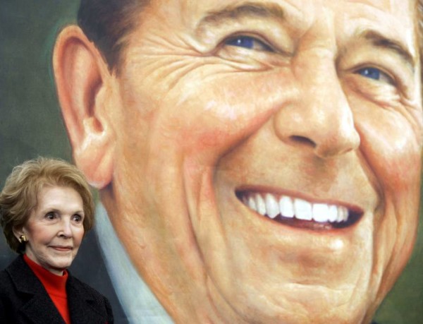 Former first lady Nancy Reagan stands next to to an image of the President Ronald Reagan commemorative postage stamp during a ceremony at the Ronald Reagan Presidential Library and Museum in Simi Valley, California in November 2004. Nancy Reagan died on March 6, 2016, at age 94, the Reagan library said. | REUTERS
