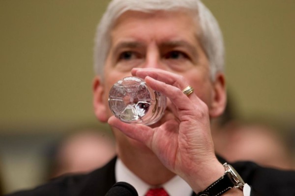 Michigan Gov. Rick Snyder drinks water as he testifies before a House Oversight and Government Reform Committee hearing in Washington, Thursday, March 17, 2016, to look into the circumstances surrounding high levels of lead found in many residents' tap water in Flint, Michigan. (AP Photo/Andrew Harnik