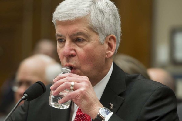 Michigan Gov. Rick Snyder drinks water as he testifies before a House Oversight and Government Reform Committee hearing in Washington, Thursday, March 17, 2016, to look into the circumstances surrounding high levels of lead found in many residents' tap water in Flint, Michigan.