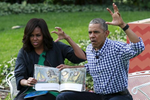 U.S. President Barack Obama @BarackObama and first lady Michelle Obama perform a reading of the children's book "Where the Wild Things Are" for children gathered for the annual White House Easter Egg Roll on the South Lawn of the White House in Washington, March 28, 2016. REUTERS/Yuri Gripas