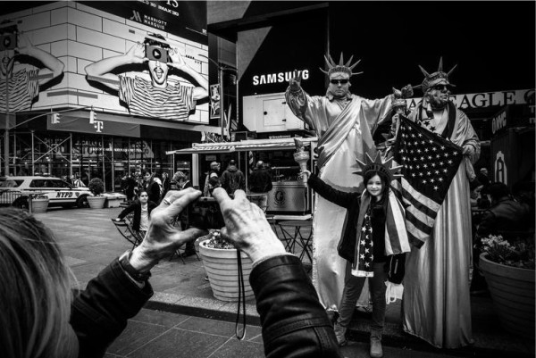 Tourists and performers fill the streets in Time Square. A New York Primary photo by Mark Peterson/Redux for MSNBC