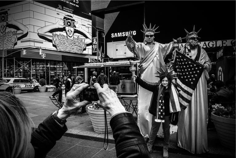 Tourists and performers fill the streets in Times Square, New York City. Photo by Mark Peterson/Redux for MSNBC