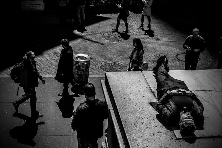 People relax in the sun near the New York Stock Exchange building in lower Manhattan. Photo by Mark Peterson/Redux for MSNBC