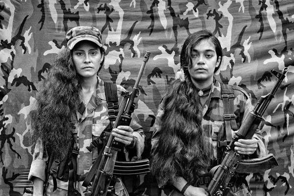 Judith and Isa, two female FARC guerrillas from the bloque movil Arturo Ruiz, inside one of the FARC camps. The Bloque Movil Arturo Ruiz of the revolutionary armed forces of Colombia (FARC) are a special unit of FARC who fight in many different regions of Colombia. This unit is like a quick reaction force who help other sub-groups of FARC. About 35% of the Colombian Territory is under the strict control of the Revolutionary Forces of Colombia, or the FARC, as the self-declared Marxist-Leninist guerrilla is known in this country, where they have operated since 1964. As a result of the total lack of infrastructures and presence of the state in these regions, the civil population living in these territories has nearly no alternatives. Poverty, the cultivation of coca leaves or the incorporation to the armed group present at the area are the only choices left. The cultivation of coca leaves is the only choice actually left to farmers, if they wish to survive and support their families. The armed groups that operate in the area guarantee the purchase of the entire harvest. Photo by Alvaro Ybarra Zavala/Getty Images Reportage