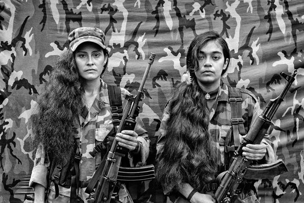  Judith and Isa, two female FARC guerrillas from the bloque movil Arturo Ruiz, inside one of the FARC camps. The Bloque Movil Arturo Ruiz of the revolutionary armed forces of Colombia (FARC) are a special unit of FARC who fight in many different regions of Colombia. This unit is like a quick reaction force who help other sub-groups of FARC. About 35% of the Colombian Territory is under the strict control of the Revolutionary Forces of Colombia, or the FARC, as the self-declared Marxist-Leninist guerrilla is known in this country, where they have operated since 1964. As a result of the total lack of infrastructures and presence of the state in these regions, the civil population living in these territories has nearly no alternatives. Poverty, the cultivation of coca leaves or the incorporation to the armed group present at the area are the only choices left. The cultivation of coca leaves is the only choice actually left to farmers, if they wish to survive and support their families. The armed groups that operate in the area guarantee the purchase of the entire harvest. Photo by Alvaro Ybarra Zavala/Getty Images Reportage