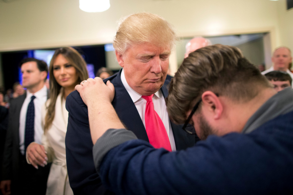 Pastor Joshua Nink prays for Donald Trump at First Christian Church in Council Bluffs, Iowa. (Jae C. Hong/Associated Press)