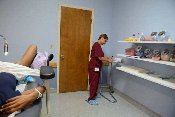 Ms. Jones updating a patient’s chart after her abortion at Buffalo Womenservices. The patients receive conscious sedation, which lessens the pain and causes amnesia, but they are aware of the procedure while it takes place. photo: Alice Provjansky.