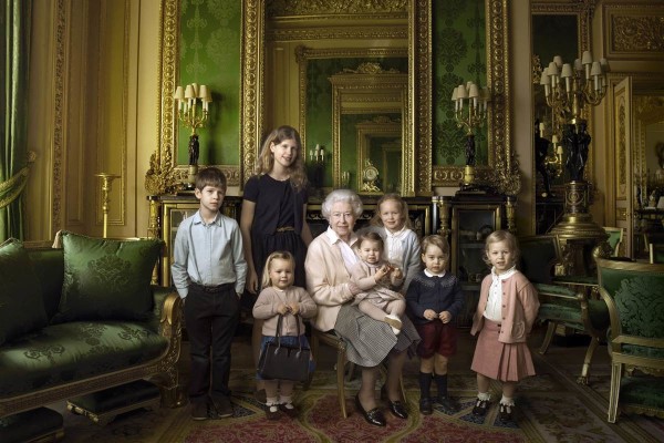 Queen Elizabeth II poses with her five great-grandchildren and her two youngest grandchildren in the Green Drawing Room, part of Windsor Castle's semi-State apartments. The children are: James, whose title is Viscount Severn, left, 8, and Lady Louise, 12, the children of Prince Edward; Mia Tindall (holding the Queen's handbag), the two year-old-daughter of Zara and Mike Tindall; Savannah, 5, and Isla Phillips, 3, right, daughters of the Queen's eldest grandson Peter Phillips and his wife Autumn; Prince George, 2, and in the Queen's arms, in the tradition of Royal portraiture, the youngest great-grandchild, Princess Charlotte, 11 months, children of the Duke and Duchess of Cambridge. Annie Leibovitz / via EPA