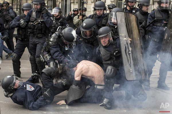 France Riot police officers detain a man during a demonstration against the labor reform in #Paris