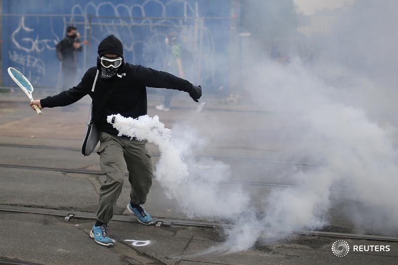 Stephane Mahe/Reuters: A protester in Nantes, France, used a tennis racket to return a tear gas canister in a demonstration on Thursday against proposed changed in French labor laws.