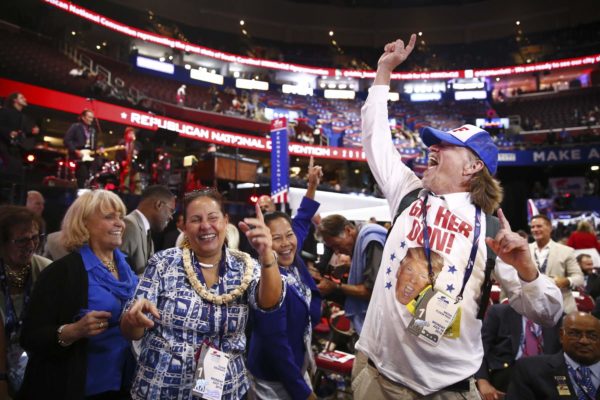 Eric Thayer / The New York Times. caption: People stand on the convention floor at the start of the Republican National Convention at the Quicken Loans Arena in Cleveland on Monday.